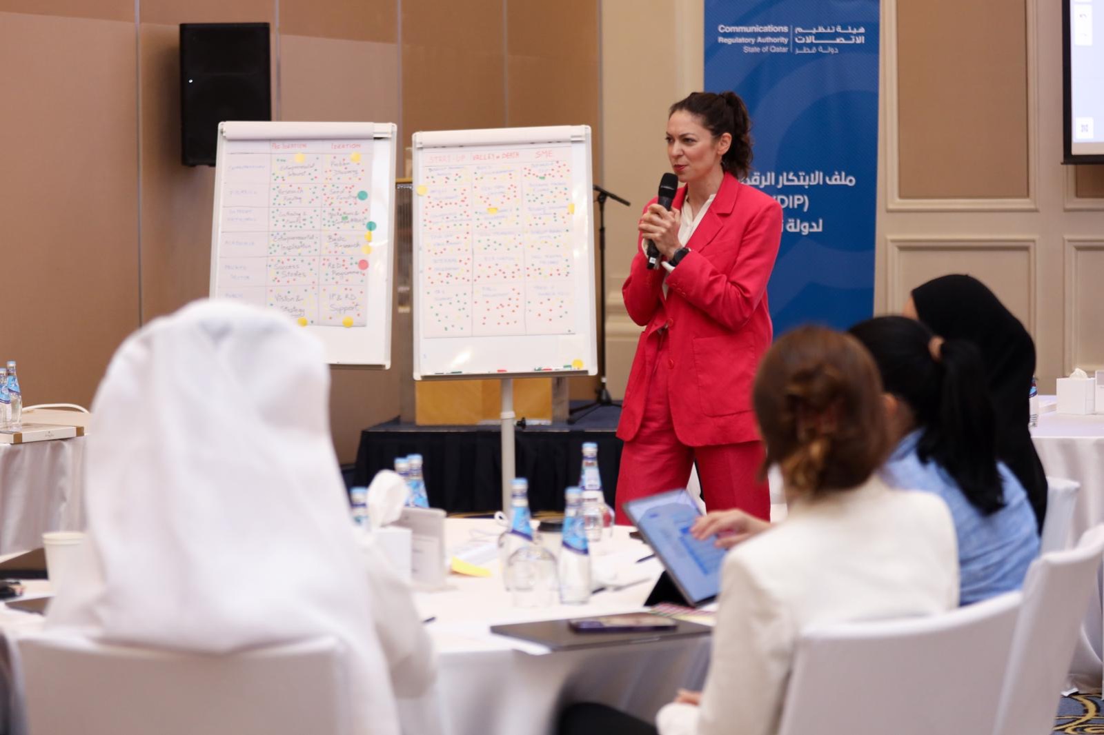 Lucy Antrobus facilitating a workshop with flip charts in Doha