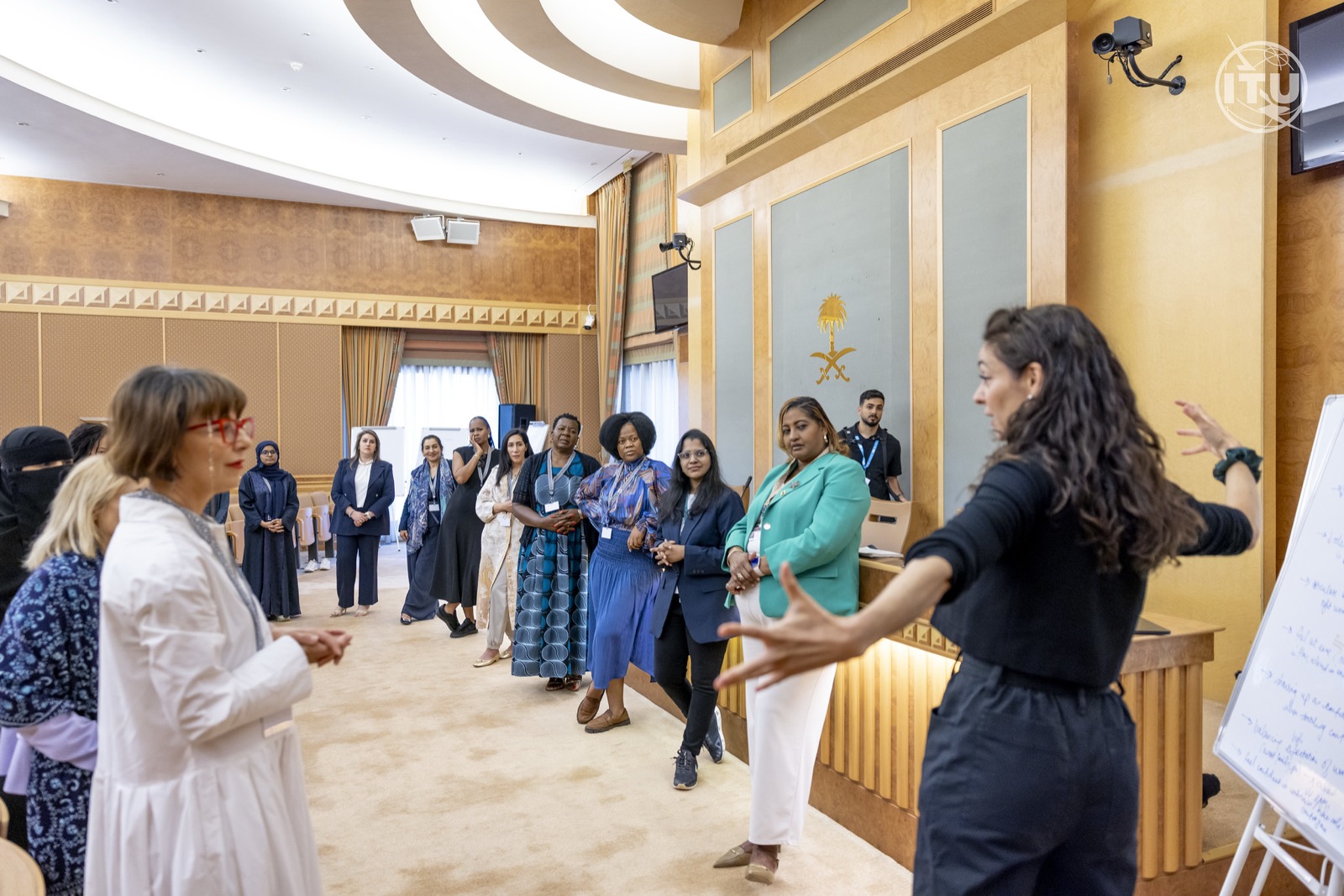 Lucy Antrobus leading an energetic group exercise with women leaders at ITU GSR-25 in Riyadh