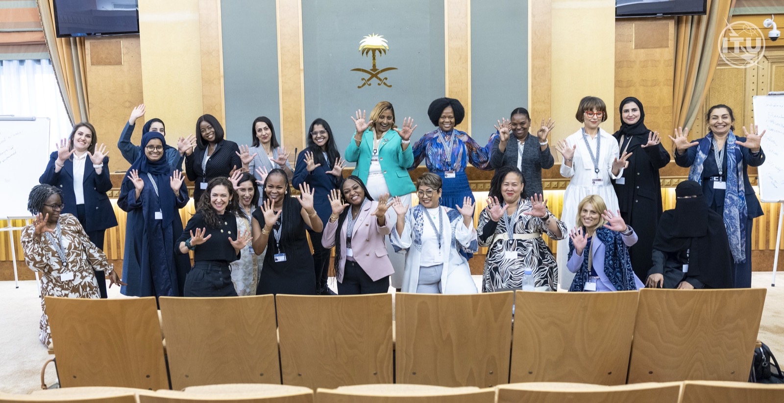 A group of women leaders celebrating with arms raised after a confidence masterclass