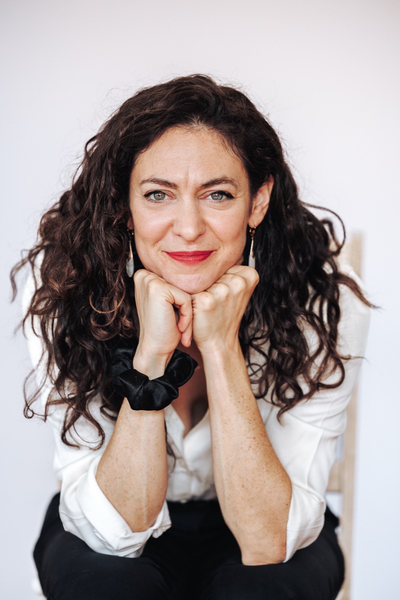 Lucy Antrobus smiling, chin resting on her hands
